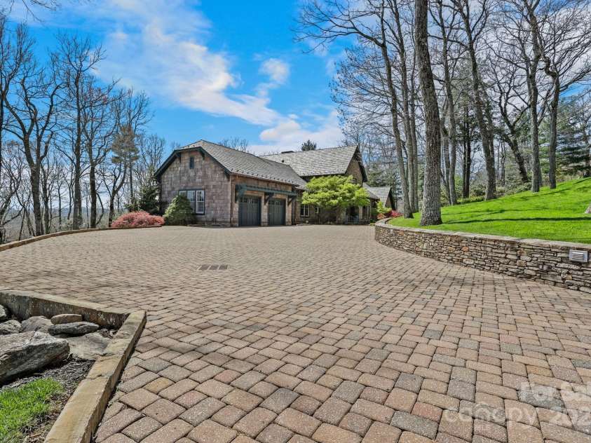 205 Indrio Road, Blowing Rock, NC 28605.  MLS# CAR4245602, YatesRealty ID 15556. Level driveway to oversized garage and parking areas.