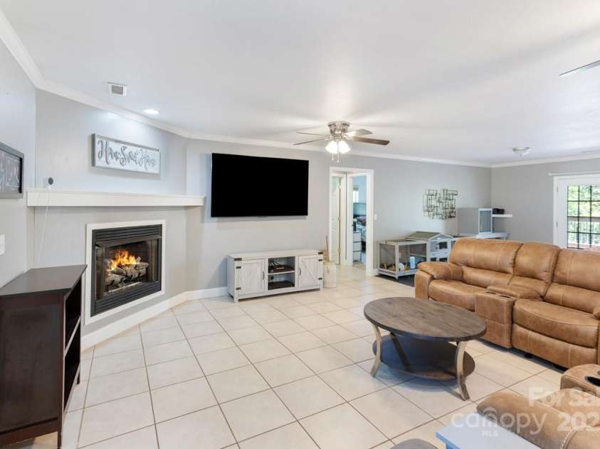 349 Penland Street, Clyde, NC 28721.  MLS# CAR4253328, YatesRealty ID 15558. Living room with gas logs