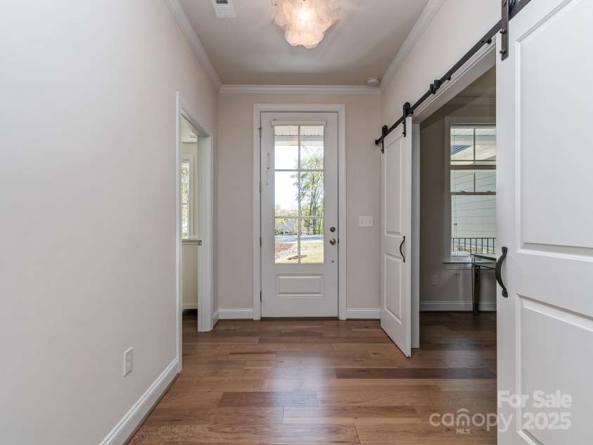 143 Robinson Ridge Drive, Mooresville, NC 28117.  MLS# CAR4246025, YatesRealty ID 15567. Foyer w/ Barn Doors to Office