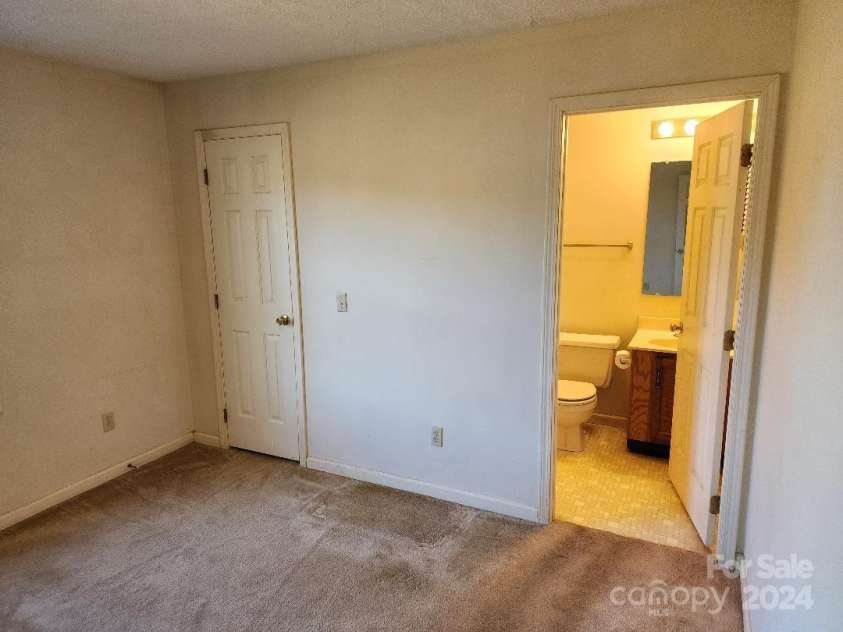 20 Coventry Lane, Burnsville, NC 28714.  MLS# CAR4199768, YatesRealty ID 1557. Primary Bedroom with view of ensuite bathroom