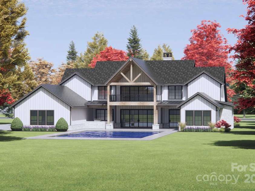 Lot 2 Country Estates Drive, Waxhaw, NC 28173.  MLS# CAR4276573, YatesRealty ID 1559. Oversized black-framed windows and sliding glass doors offer panoramic views, infuse the home with natural light, and create a seamless indoor-outdoor flow. (2nd-story porch and pool not included).