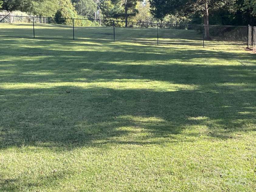 232 Gold Street, New London, NC 28127.  MLS# CAR4309607, YatesRealty ID 156. Back yard with fenced in area...back yard is beyond fenced area