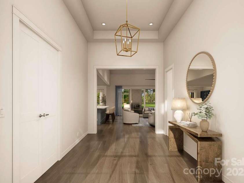 Lot 4 Country Estates Drive, Waxhaw, NC 28173.  MLS# CAR4278303, YatesRealty ID 1561. This elegant foyer sets a refined tone with its high tray ceiling, soft neutral palette, and sleek wood floors that flow seamlessly into the main living area.