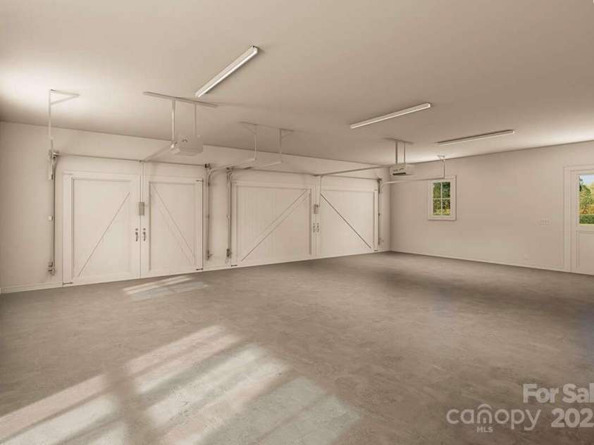 Lot 4 Country Estates Drive, Waxhaw, NC 28173.  MLS# CAR4278303, YatesRealty ID 1561. This oversized three-car garage features carriage-style doors, durable concrete flooring, multiple windows for natural light, modern openers, and a convenient side entry.