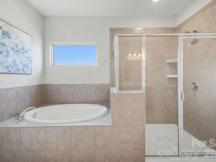 514 Tack Lane, Midland, NC 28107.  MLS# CAR4358317, YatesRealty ID 15618. Soaking tub and step in shower