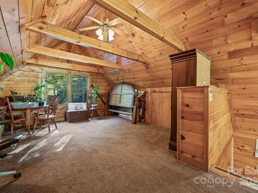 171 Irene Lane, Maggie Valley, NC 28751.  MLS# CAR4193190, YatesRealty ID 15661. Loft open to great room below.  Access to attic storage on knee wall thru wooden doors
