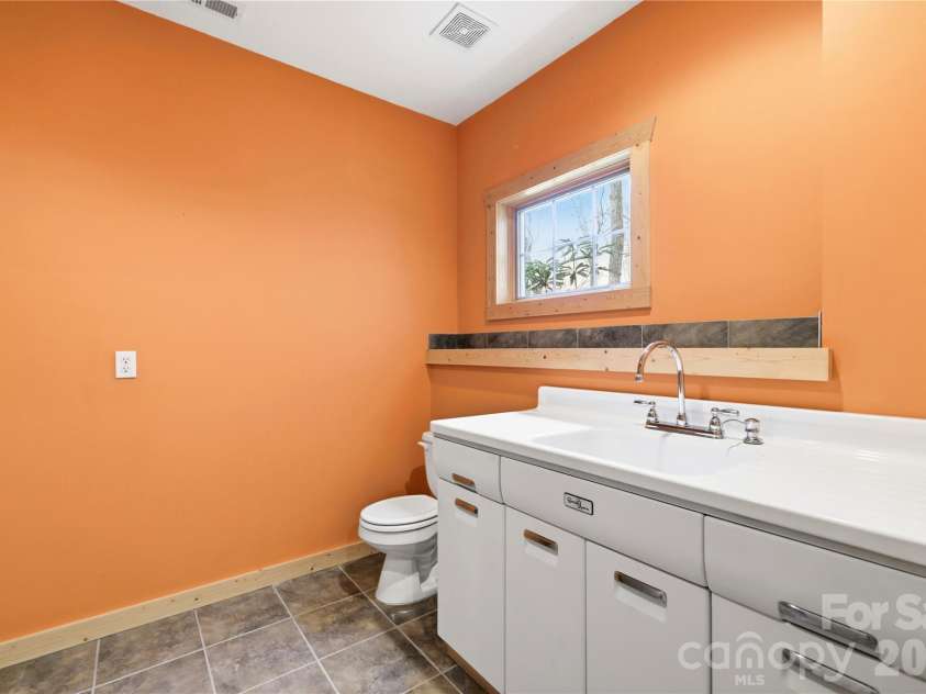 2320 Evans Road, Hendersonville, NC 28739.  MLS# CAR4366664, YatesRealty ID 15670. Basement half bath/2nd laundry or flex use