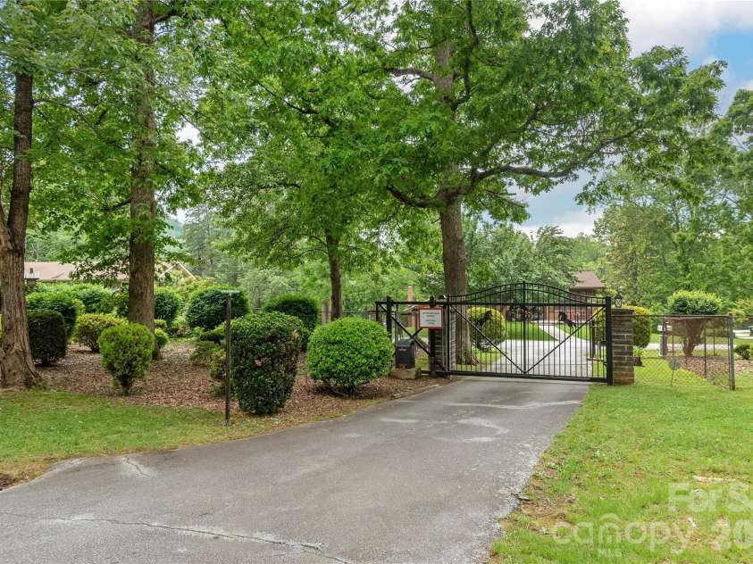 204 Reed Drive, Flat Rock, NC 28731.  MLS# CAR4355260, YatesRealty ID 15674. Exit from home.  Love that landscaping!
