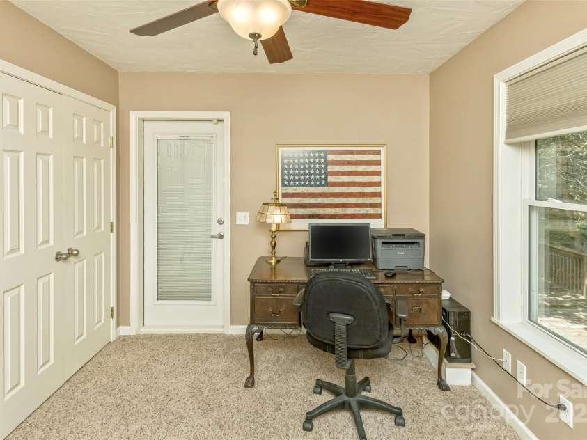 15 Beaverdam Knoll Road, Asheville, NC 28804.  MLS# CAR4283730, YatesRealty ID 1568. The office/nursery has generous storage closets with shelving, access to the covered deck and a beautiful view to the backyard.