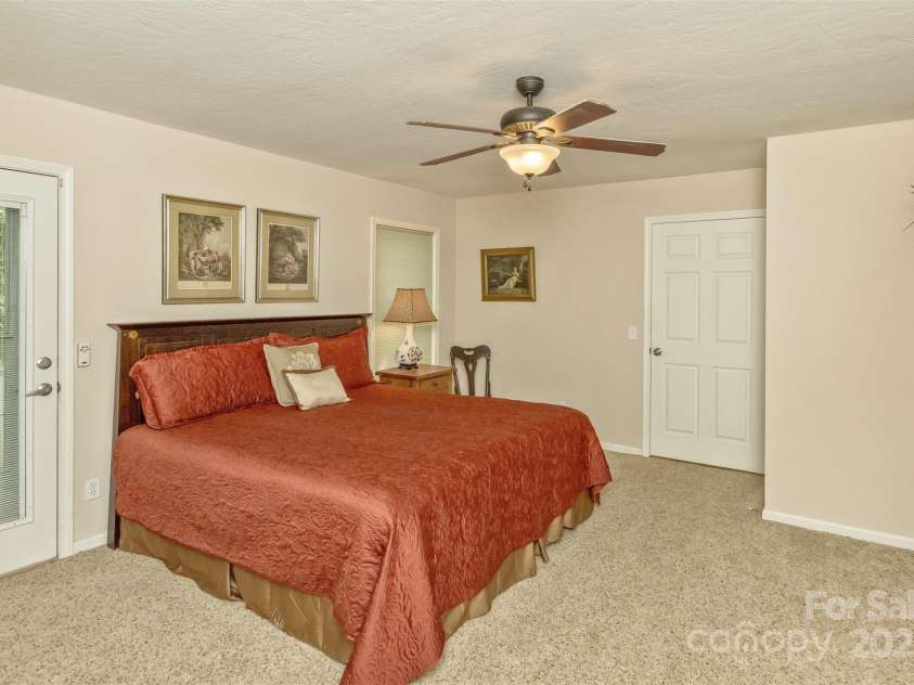 15 Beaverdam Knoll Road, Asheville, NC 28804.  MLS# CAR4283730, YatesRealty ID 1568. The second bedroom on the main floor also could serve as the primary suite. It features an ensuite bathroom with double vanity, two closets and a shower/tub.