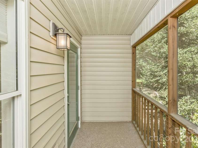 15 Beaverdam Knoll Road, Asheville, NC 28804.  MLS# CAR4283730, YatesRealty ID 1568. What a cozy delight to have a screened balcony porch off the primary suite to enjoy the cool mountain mornings.