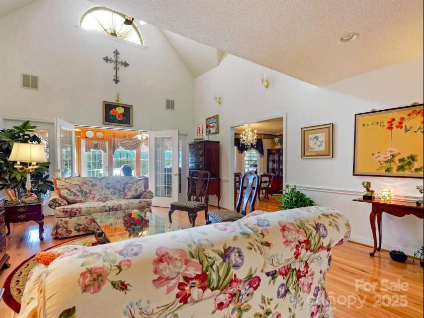 510 Floyd Blackwell Road, Tryon, NC 28782.  MLS# CAR3939567, YatesRealty ID 1568. Living Room opening out to a 4 seasons sun porch