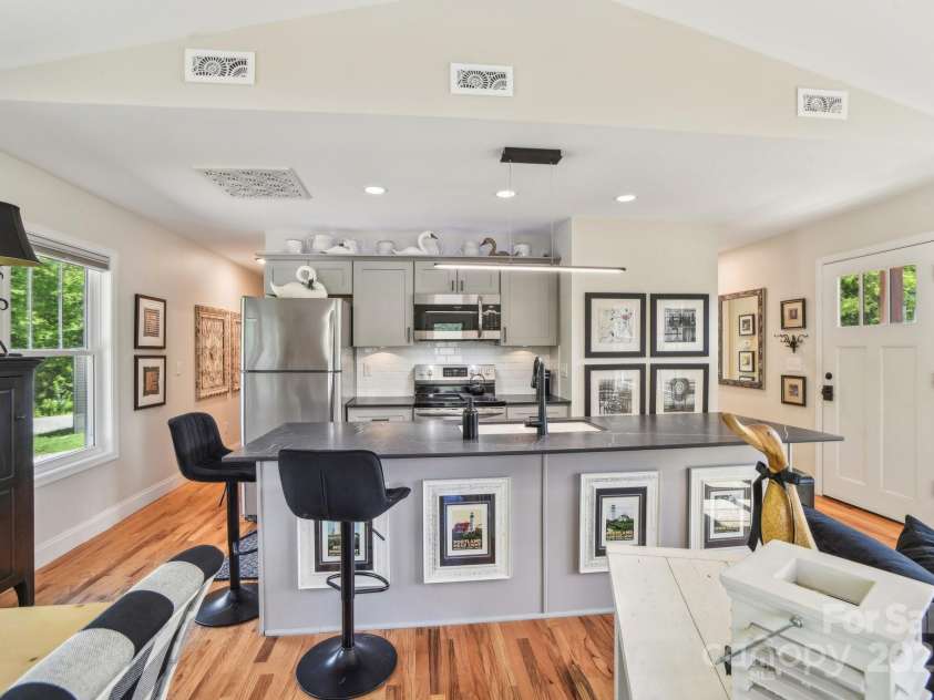 9 Circle Drive, Black Mountain, NC 28711.  MLS# CAR4260626, YatesRealty ID 15687. Kitchen open to the living and dining areas with a breakfast bar.