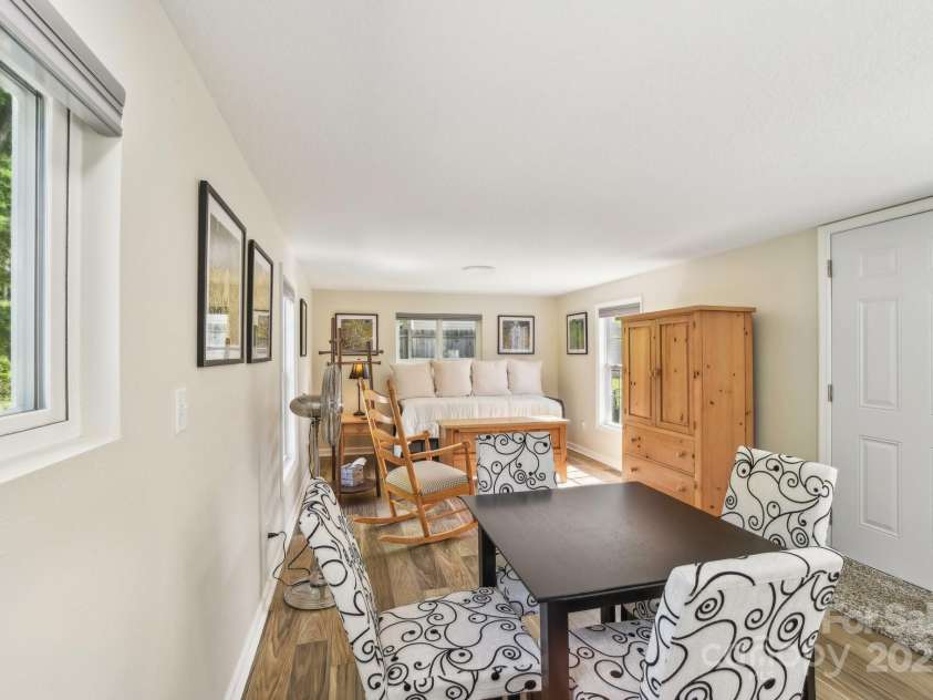 9 Circle Drive, Black Mountain, NC 28711.  MLS# CAR4260626, YatesRealty ID 15687. Looking from kitchen through the dining and living spaces; all open to each other.