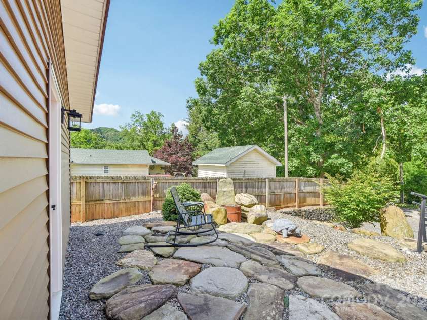 9 Circle Drive, Black Mountain, NC 28711.  MLS# CAR4260626, YatesRealty ID 15687. Stone patio behind the garage.