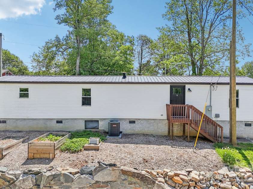 9 Circle Drive, Black Mountain, NC 28711.  MLS# CAR4260626, YatesRealty ID 15687. This manufactured home has been totally rebuilt. Has its own gravel parking space.