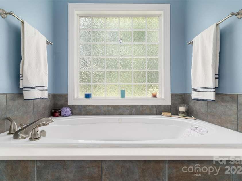 18118 Pompano Place, Cornelius, NC 28031.  MLS# CAR4263080, YatesRealty ID 15689. Great soaker tub with block window to let the light in.