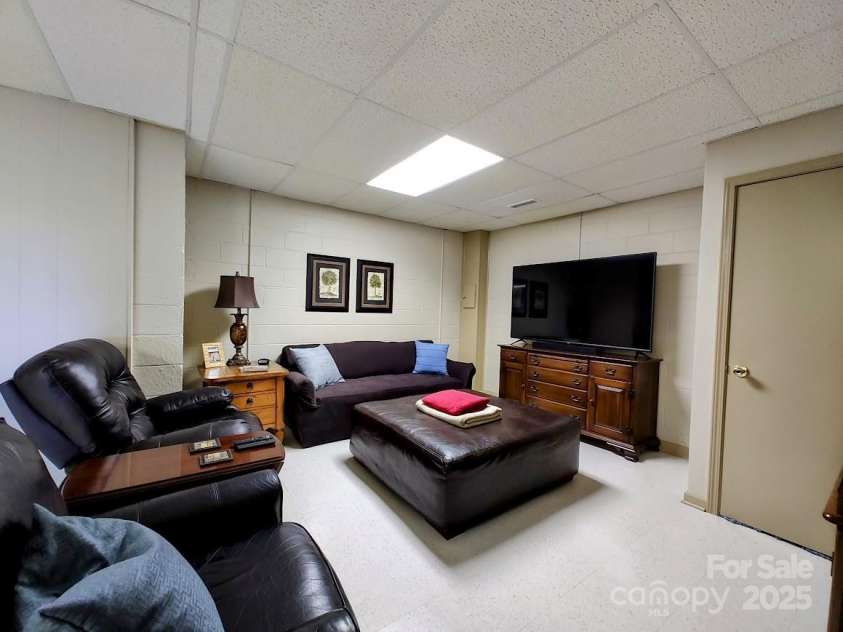 545 Summit Road, Tryon, NC 28782.  MLS# CAR4293286, YatesRealty ID 1571. Downstairs Den Area