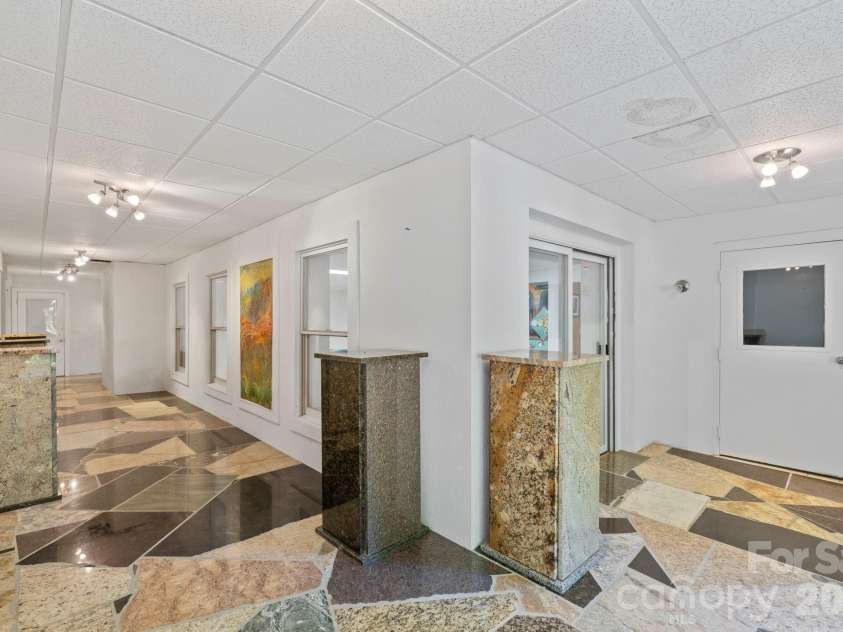 652 Avery Creek Road, Arden, NC 28704.  MLS# CAR4282113, YatesRealty ID 15716. Lower level surrounding game room