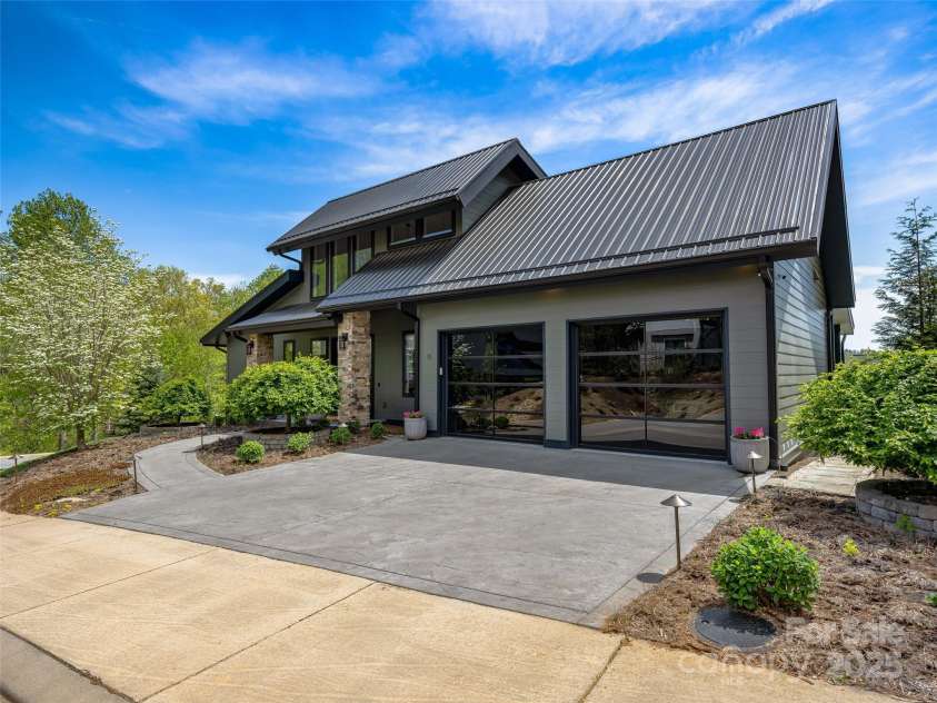 11 Bayonne Trail, Asheville, NC 28804.  MLS# CAR4250937, YatesRealty ID 15735. Unique garage door panels set a welcoming tone