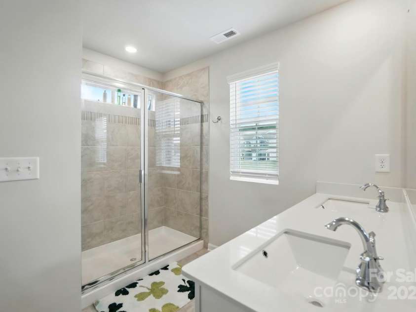 6037 Chelsea Oaks Ridge, Tega Cay, SC 29708.  MLS# CAR4258729, YatesRealty ID 15742. Primary Bath Walk-in Shower Dual Sinks