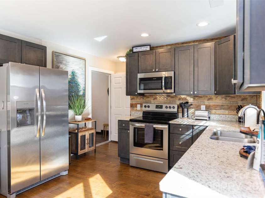 312 Jenna Clare Lane, Asheville, NC 28803.  MLS# CAR4197644, YatesRealty ID 15748. This sleek & sophisticated urban sanctuary is well equipped with quality finishes including granite counters, engineered hardwoods and a finished garage space.