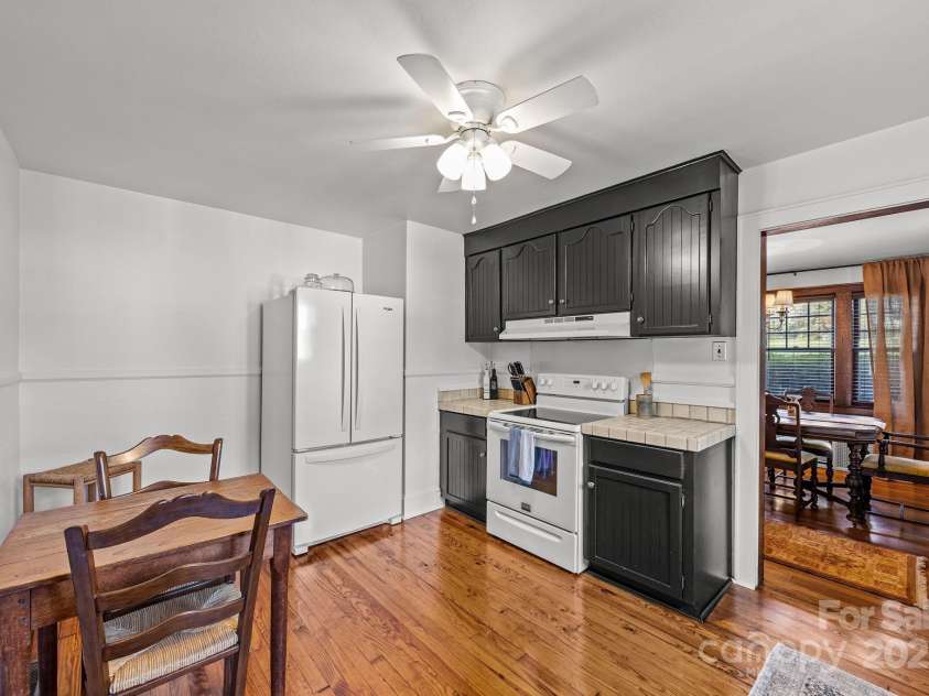 495 Fairview Road, Asheville, NC 28803.  MLS# CAR4305953, YatesRealty ID 15769. Refinished original floors in eat-in kitchen