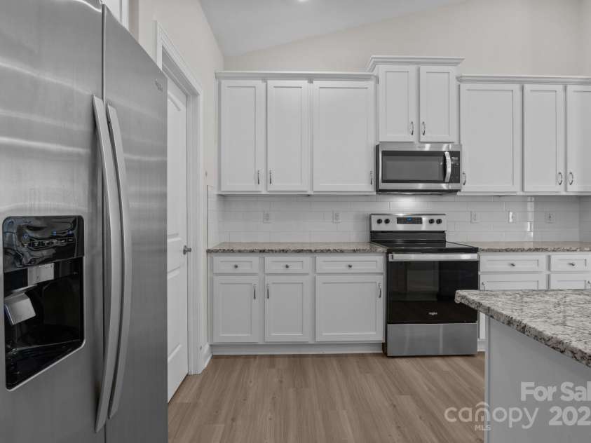 127 Tradesmen Trail, Troutman, NC 28166.  MLS# CAR4223474, YatesRealty ID 15779. KitchenThe modern kitchen boasts stainless steel appliances, ample cabinetry, and a large island with seating. Its functional layout is ideal for both everyday cooking and hosting gatherings.