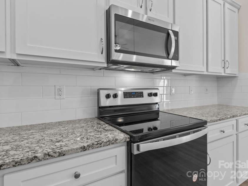 127 Tradesmen Trail, Troutman, NC 28166.  MLS# CAR4223474, YatesRealty ID 15779. KitchenThe modern kitchen boasts stainless steel appliances, ample cabinetry, and a large island with seating. Its functional layout is ideal for both everyday cooking and hosting gatherings.