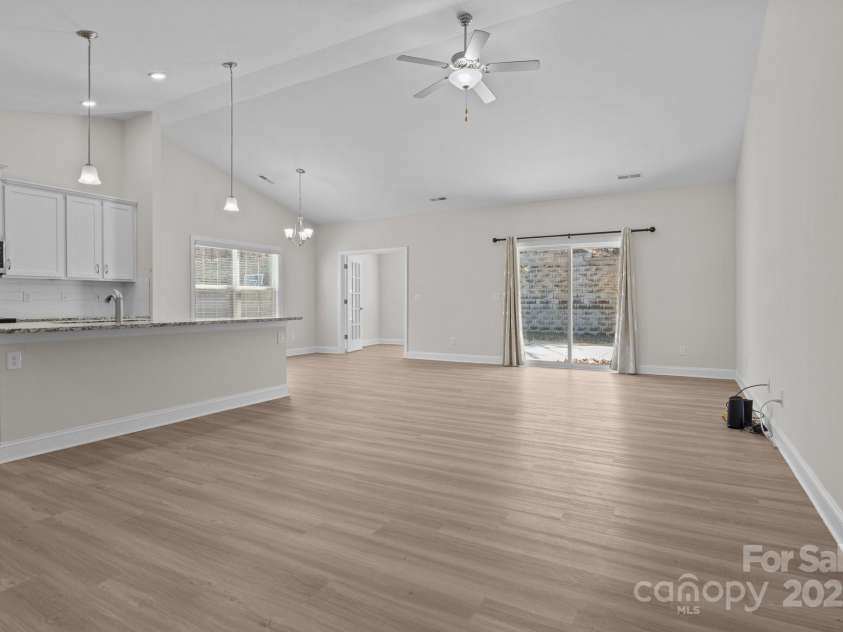 127 Tradesmen Trail, Troutman, NC 28166.  MLS# CAR4223474, YatesRealty ID 15779. Step into the spacious living room featuring abundant natural light and an open floor plan that seamlessly connects to the dining and kitchen areas. The neutral color palette and contemporary finishes create a warm and 