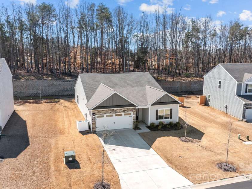 127 Tradesmen Trail, Troutman, NC 28166.  MLS# CAR4223474, YatesRealty ID 15779. The aerial view of the home showcases its charming curb appeal, with an easy-to-maintain lawn that adds to the property's overall appeal. The plenty of driveway space provides ample parking, making it convenient for gue