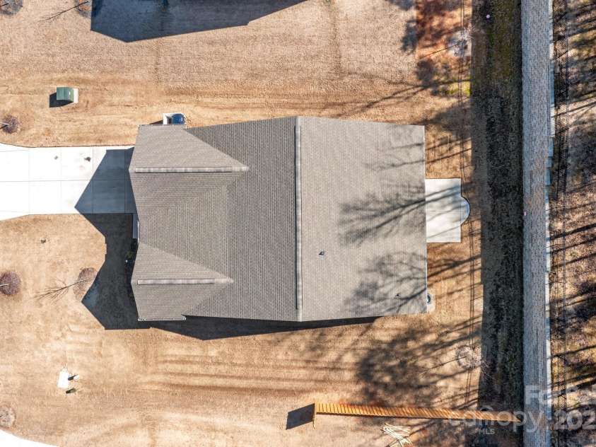 127 Tradesmen Trail, Troutman, NC 28166.  MLS# CAR4223474, YatesRealty ID 15779. The aerial view of the home showcases its charming curb appeal, with an easy-to-maintain lawn that adds to the property's overall appeal. The plenty of driveway space provides ample parking, making it convenient for gue