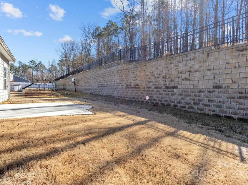 127 Tradesmen Trail, Troutman, NC 28166.  MLS# CAR4223474, YatesRealty ID 15779. The backyard offers a private outdoor space, perfect for relaxation or entertaining. The well-maintained lawn provides ample room for various outdoor activities.