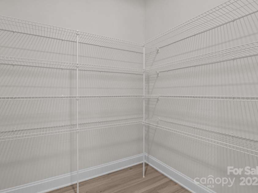 127 Tradesmen Trail, Troutman, NC 28166.  MLS# CAR4223474, YatesRealty ID 15779. The very large walk-in pantry, just off the kitchen, offers an abundance of storage space for all your kitchen essentials. With plenty of shelves and room to organize, it provides the perfect solution for keeping your p