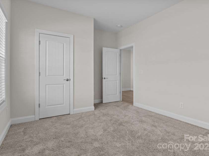 127 Tradesmen Trail, Troutman, NC 28166.  MLS# CAR4223474, YatesRealty ID 15779. Two additional bedrooms provide comfortable accommodations, each featuring plush carpeting, ample closet space, and plenty of natural light. These rooms are versatile, making them ideal for owners, guests, or a flex spa