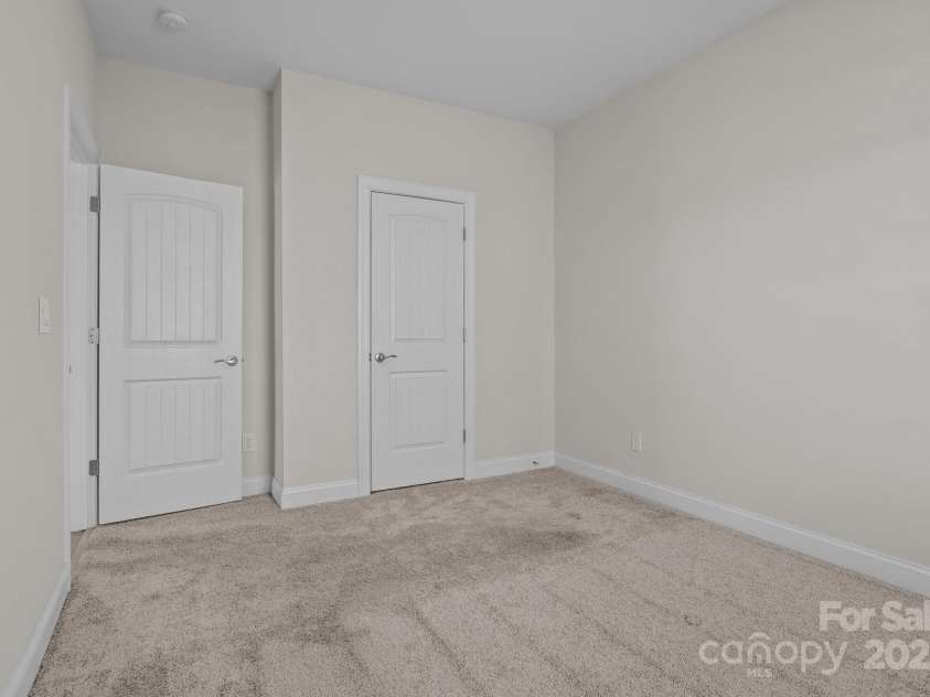 127 Tradesmen Trail, Troutman, NC 28166.  MLS# CAR4223474, YatesRealty ID 15779. Two additional bedrooms provide comfortable accommodations, each featuring plush carpeting, ample closet space, and plenty of natural light. These rooms are versatile, making them ideal for owners, guests, or a flex spa