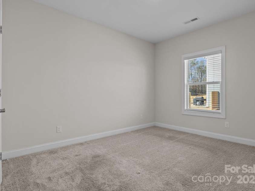 127 Tradesmen Trail, Troutman, NC 28166.  MLS# CAR4223474, YatesRealty ID 15779. Two additional bedrooms provide comfortable accommodations, each featuring plush carpeting, ample closet space, and plenty of natural light. These rooms are versatile, making them ideal for owners, guests, or a flex spa