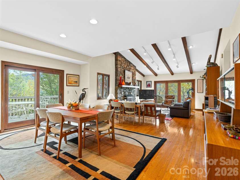 80 Stony Ridge, Asheville, NC 28804.  MLS# CAR4321949, YatesRealty ID 15789. Open-concept design visible from the foyer, featuring vaulted ceiling with wood beams, track lighting and wraparound deck access.