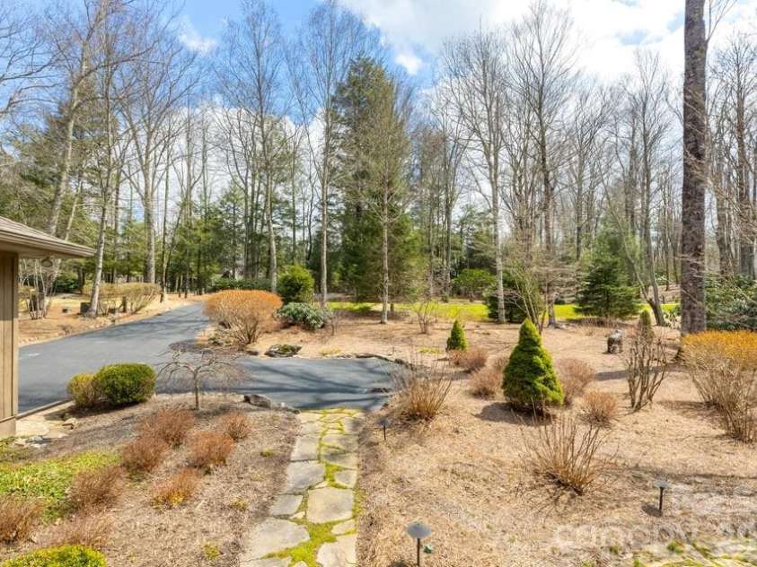 174 Garnet Rock Trail, Highlands, NC 28741.  MLS# CAR4365412, YatesRealty ID 15834. Large, fairly level front yard.