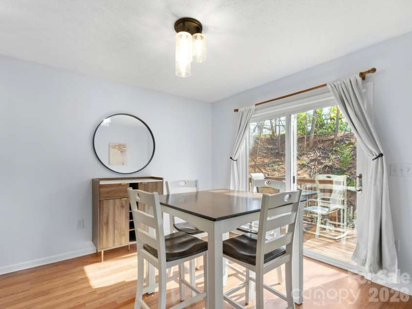 1 Mosers Place, Candler, NC 28715.  MLS# CAR4361004, YatesRealty ID 15858. Dining Opens to Side Porch