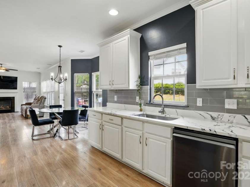 8833 Cavonnier Lane, Charlotte, NC 28216.  MLS# CAR4254092, YatesRealty ID 15858. Kitchen sink overlooks the backyard and is open to the living room