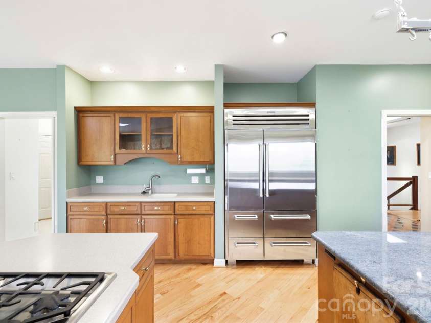 100 Elmridge Drive, Flat Rock, NC 28731.  MLS# CAR4366738, YatesRealty ID 15859. Appliances include a Sub-Zero refrigerator, Thermador gas cooktop, and wall oven