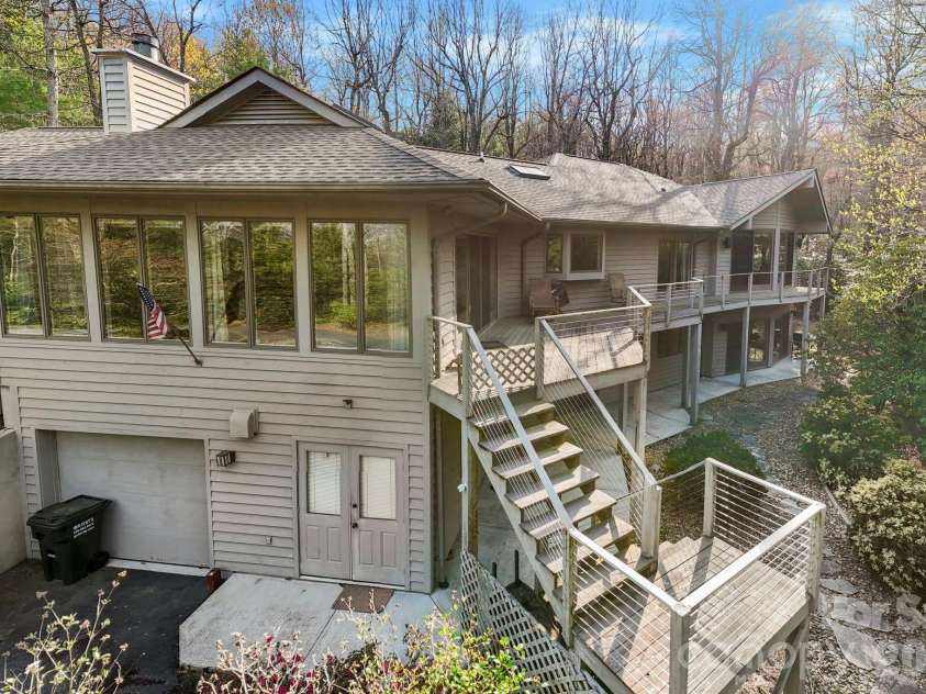100 Elmridge Drive, Flat Rock, NC 28731.  MLS# CAR4366738, YatesRealty ID 15859. Deck on back of home overlooks quiet forest