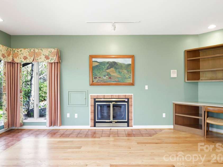 100 Elmridge Drive, Flat Rock, NC 28731.  MLS# CAR4366738, YatesRealty ID 15859. Den includes desk area.  Little door next to fireplace is to bring wood in from garage.