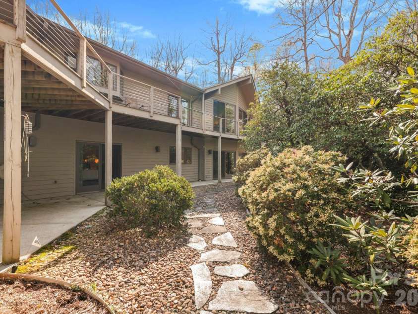 100 Elmridge Drive, Flat Rock, NC 28731.  MLS# CAR4366738, YatesRealty ID 15859. Expansive deck overlooking nature