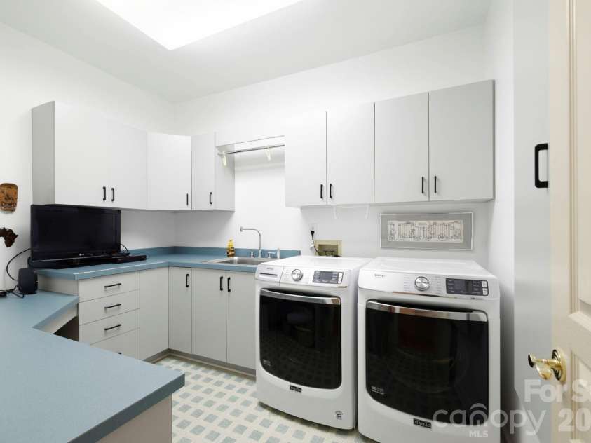 100 Elmridge Drive, Flat Rock, NC 28731.  MLS# CAR4366738, YatesRealty ID 15859. Laundry room in hallway near bedrooms