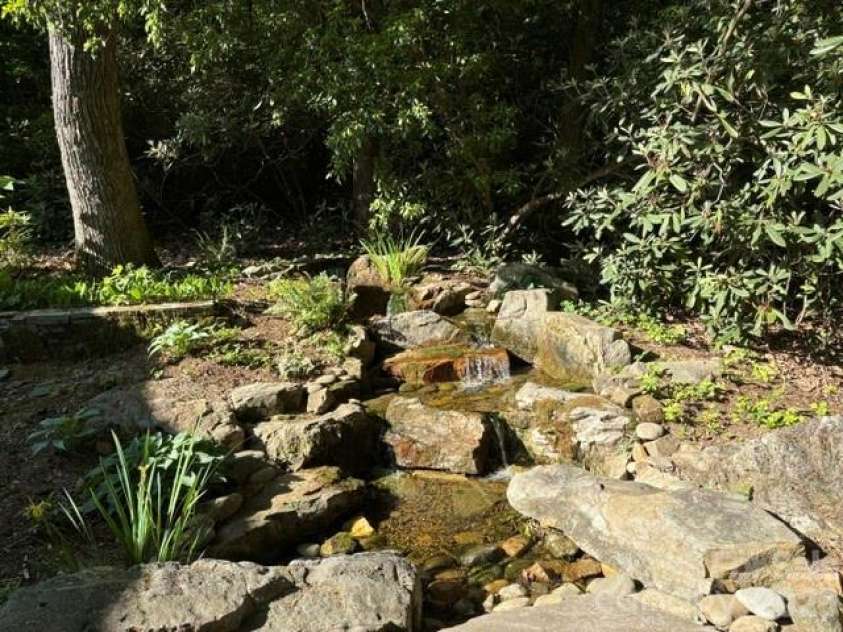 100 Elmridge Drive, Flat Rock, NC 28731.  MLS# CAR4366738, YatesRealty ID 15859. Outdoor water feature provides soothing sounds