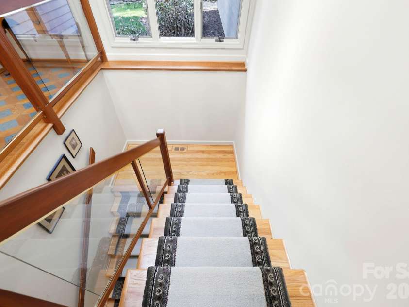 100 Elmridge Drive, Flat Rock, NC 28731.  MLS# CAR4366738, YatesRealty ID 15859. Stairs with glass railings