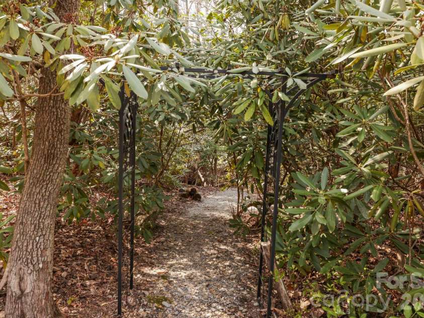 100 Elmridge Drive, Flat Rock, NC 28731.  MLS# CAR4366738, YatesRealty ID 15859. Walking trails lead to a creek