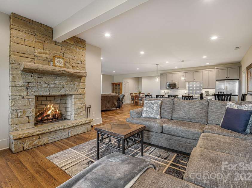 360 Turkey Branch Road, Mars Hill, NC 28754.  MLS# CAR4218460, YatesRealty ID 1586. Downstairs living room with wood burning fireplace.